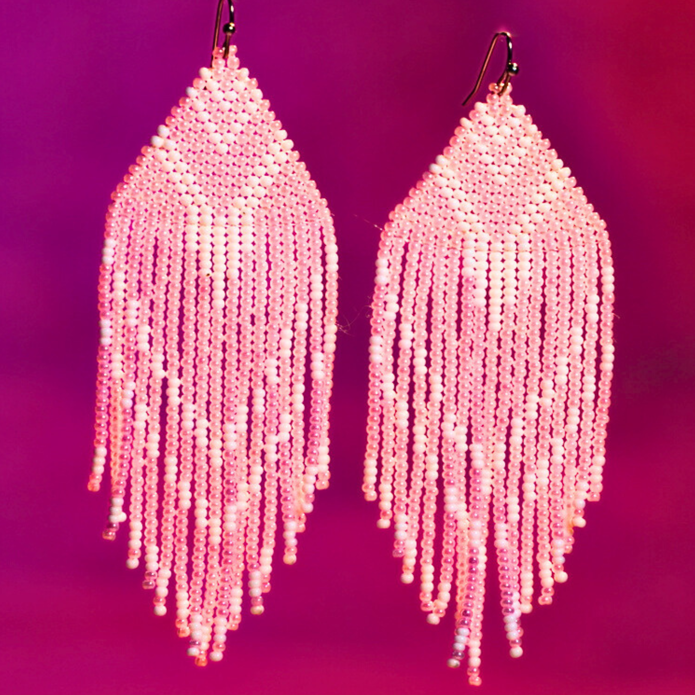 Close-up image of Aditi Earrings, handmade with pink beads and intricate detailing, perfect for elegant looks.