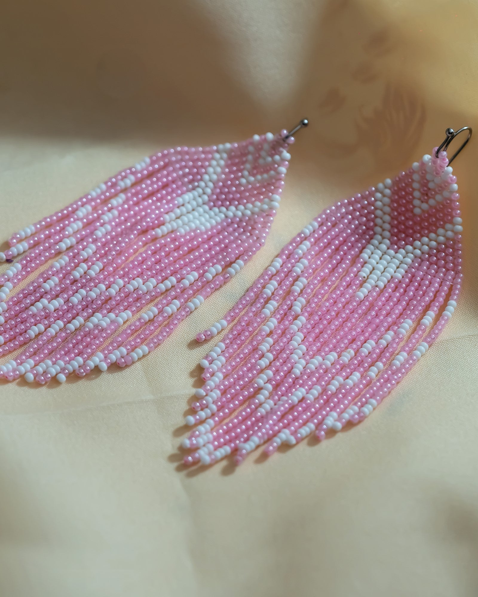 Front view of Aditi Earrings, handmade with pink beads, showcasing intricate craftsmanship and elegant design.